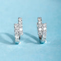 Small diamond ear clip earrings in white gold colour copper with geometric ring design, one pair