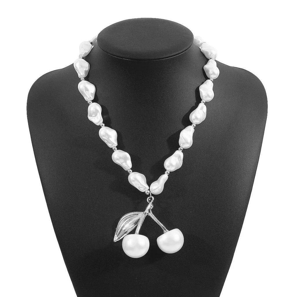Gold and white K electroplated alloy necklace with irregular cherry fruit pendant and imitation pearls, adjustable chain.