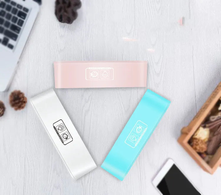 Blue rectangular LED digital alarm clock with multicoloured lighting and Bluetooth speaker on a bedside table.