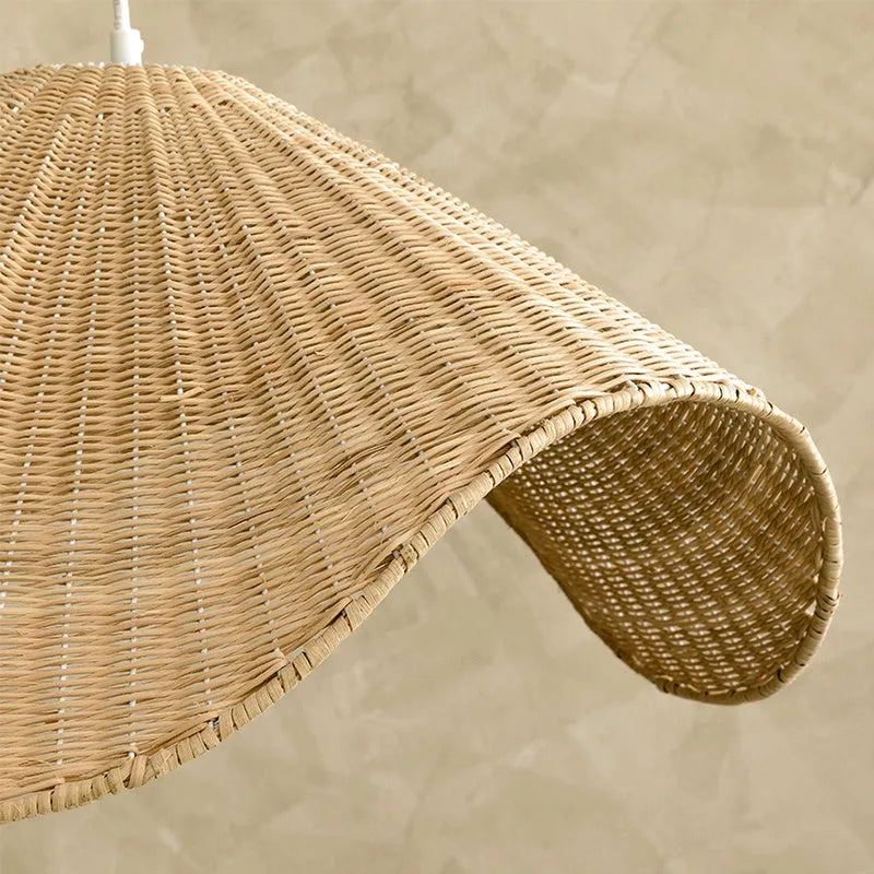 Handmade natural rattan and willow bamboo chandelier with warm LED light in a rustic setting.