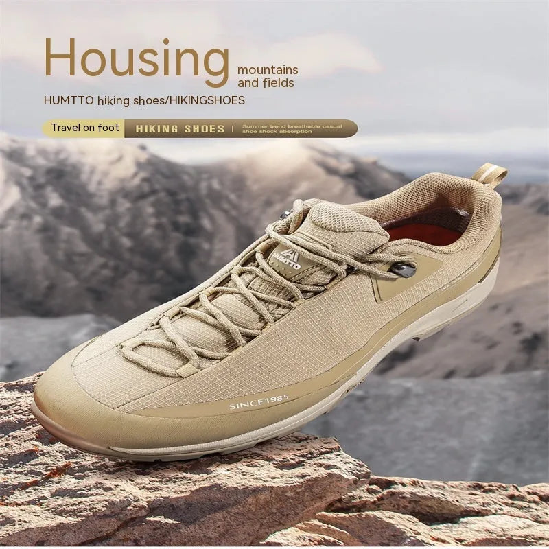 Men's low-top mountain climbing shoes in black with leather mesh upper and non-slip rubber outsole
