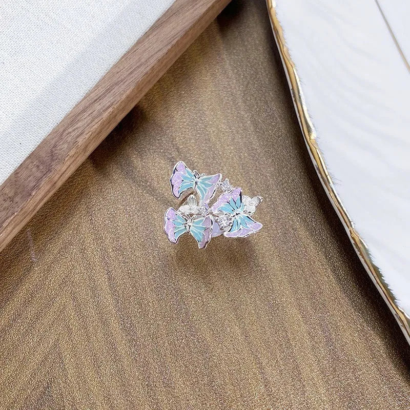 Adjustable copper insect ring with hand-dripped oil finish in silver, pink, or blue colour variations