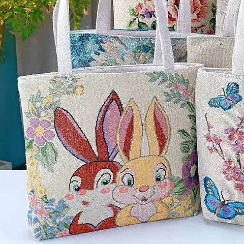 Double-sided embroidered canvas bag with gold wire detailing showing botanical pattern