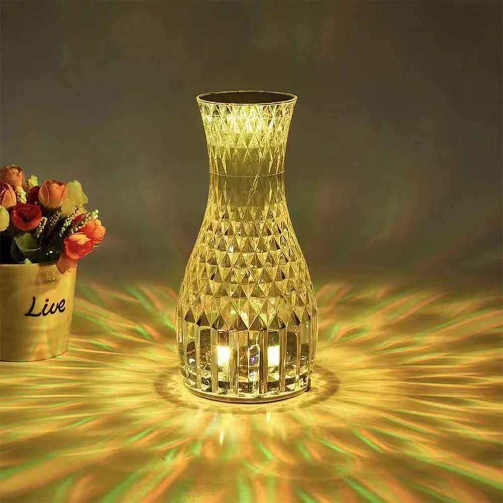 Crystal vase-shaped table lamp with remote control on wooden bedside table