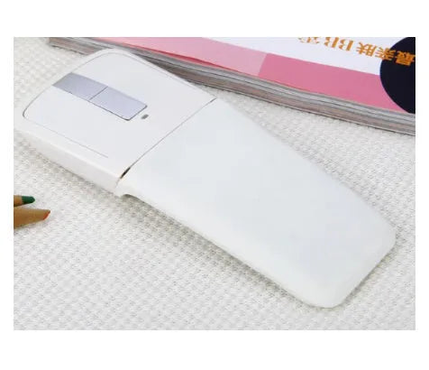 Folded Bluetooth wireless mouse showing compact size with touch surface and multiple colour options