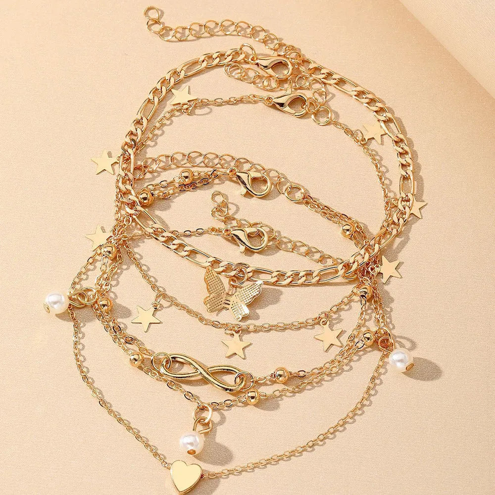 Four-piece women's anklet set with butterfly and pearl heart designs in alloy