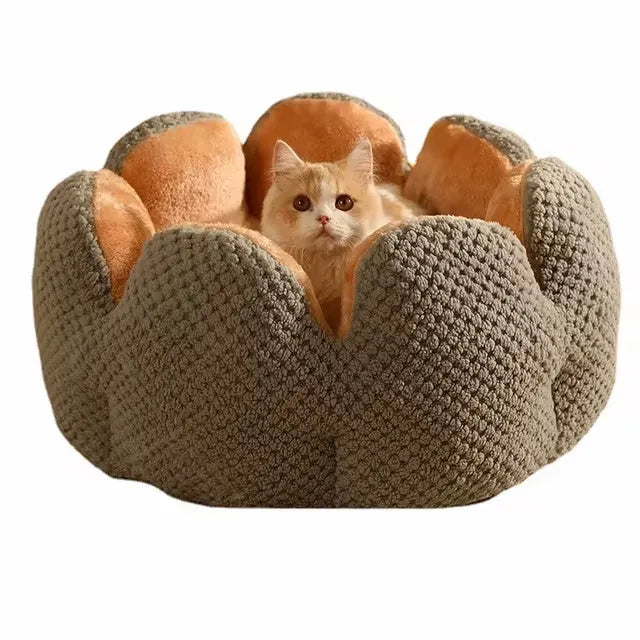 Green cactus petal-shaped soft plush pet bed for cat or dog on a hardwood floor.