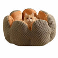 Green cactus petal-shaped soft plush pet bed for cat or dog on a hardwood floor.