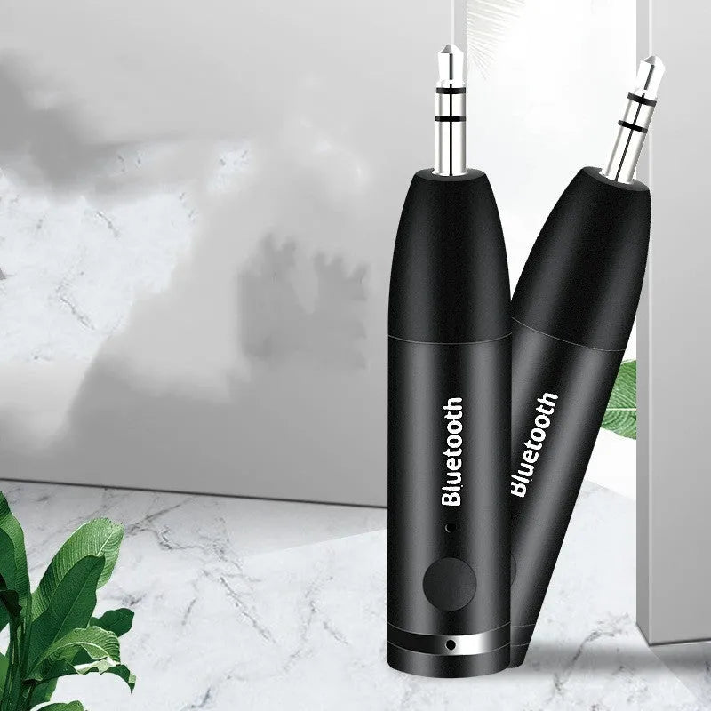 Black Bluetooth audio receiver for car stereo with AUX connection and USB power cable