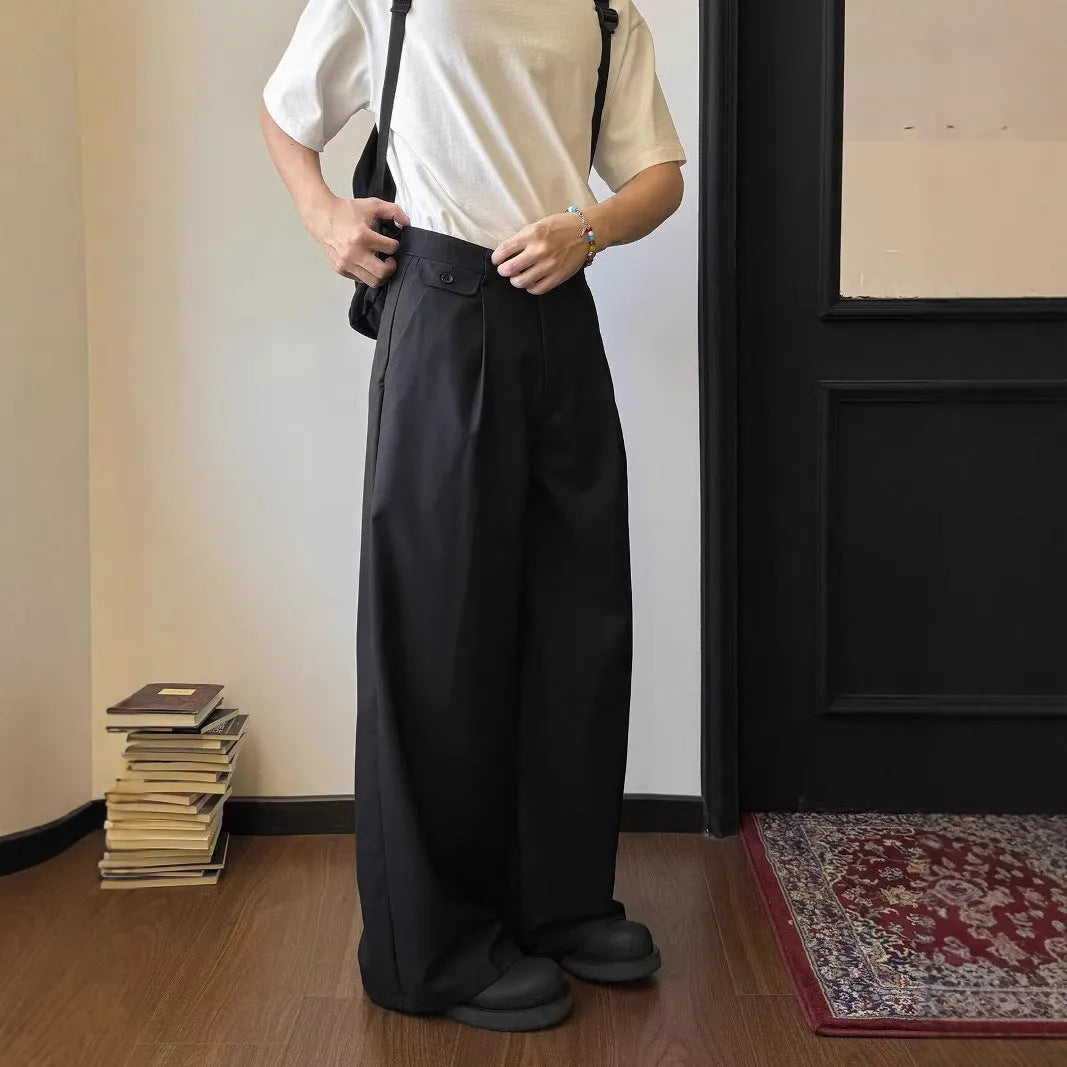 Men's brown straight-leg casual trousers with a loose, wide-leg fit on a neutral background.