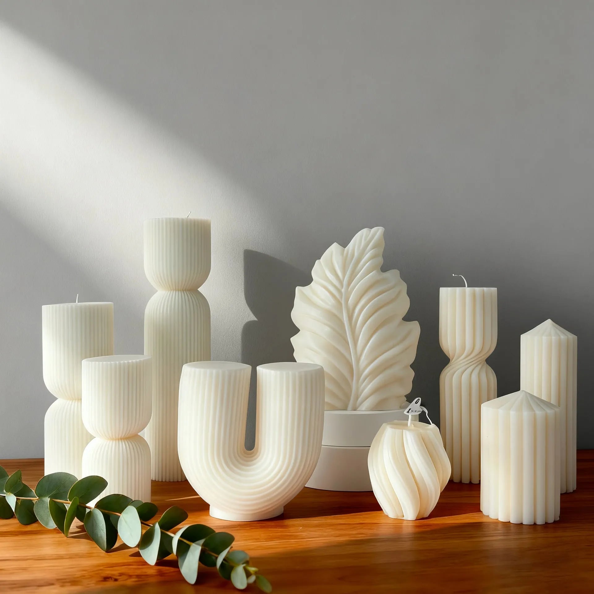 White cylindrical soy wax aromatherapy candle with geometric spherical shape on a table