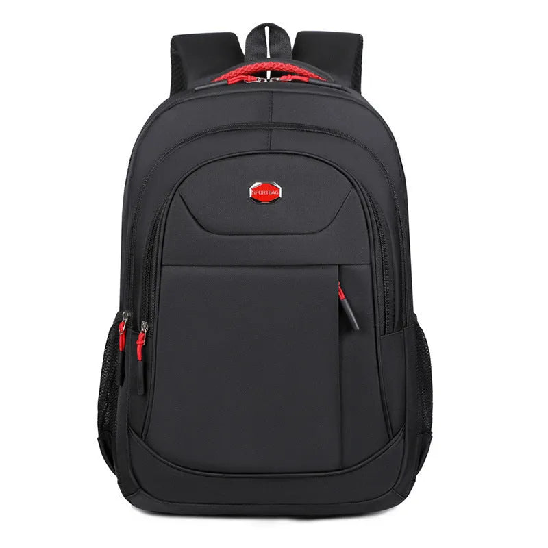 Solid colour Oxford cloth student backpack with curved shoulder straps and multiple storage compartments.