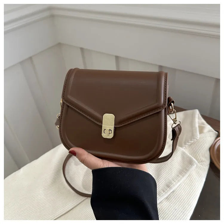 Soft PU leather shoulder messenger bag with clamshell opening in khaki colour, shown from the front.