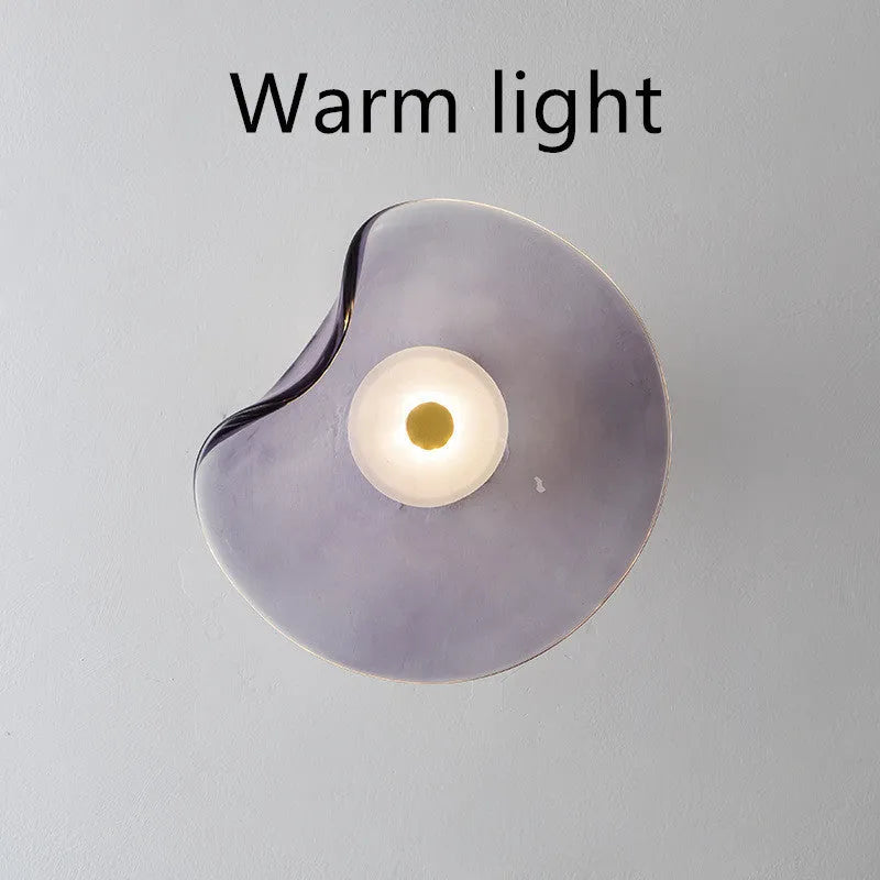 Round decorative wall lamp with glass shade in cognac colour for bedroom bedside lighting
