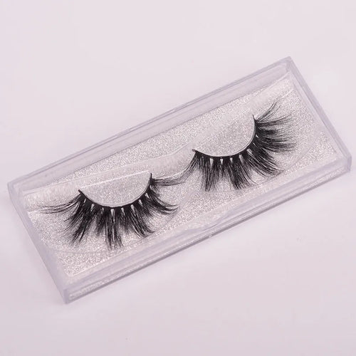 5D mink false eyelashes set with hair storage cap and double-headed brush on a clean surface.