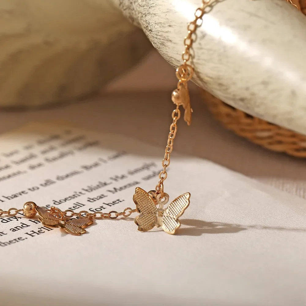 Alloy hollow butterfly design anklet in gold finish on a woman's ankle, beach foot ornament style