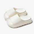 Women's beige EVA fish mouth slippers with a thick 5.5cm sole on a tiled floor.