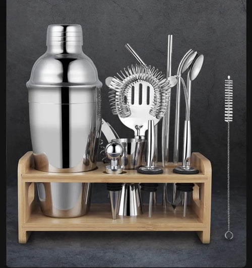 Silver 23-piece stainless steel and acrylic home cocktail set with bartender tools laid out.