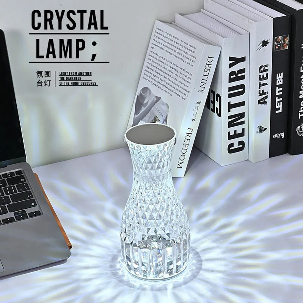Crystal vase-shaped table lamp with remote control on wooden bedside table