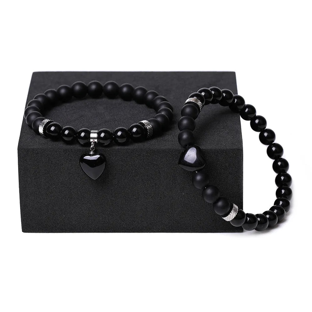 Matching natural stone couple bracelets with heart-shaped charms in multiple stone type options