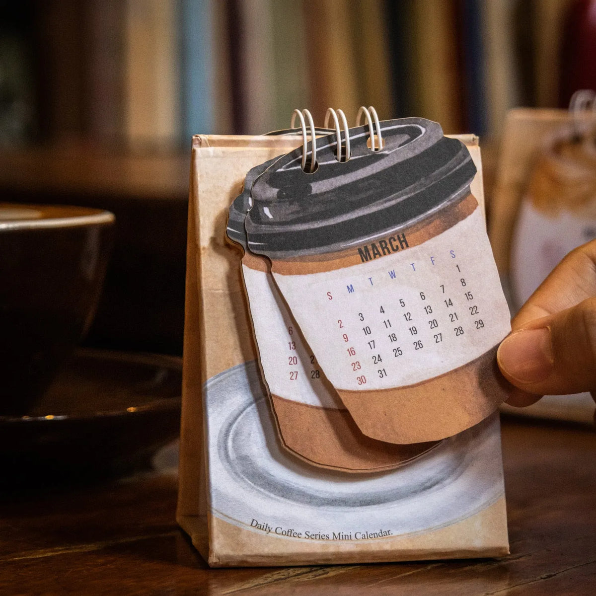 Coffee-themed mini desk calendar for 2025 with motivational designs for compact organisation