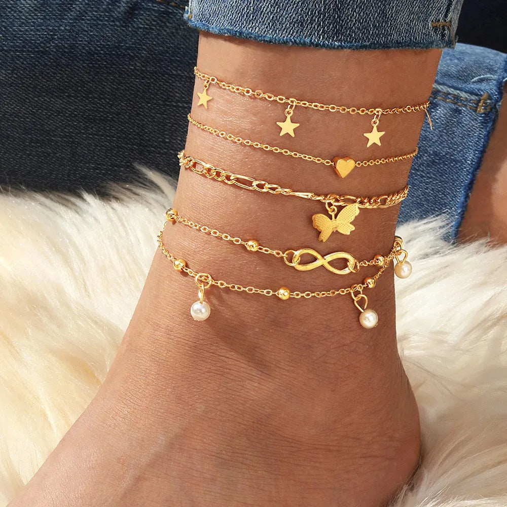 Four-piece women's anklet set with butterfly and pearl heart designs in alloy