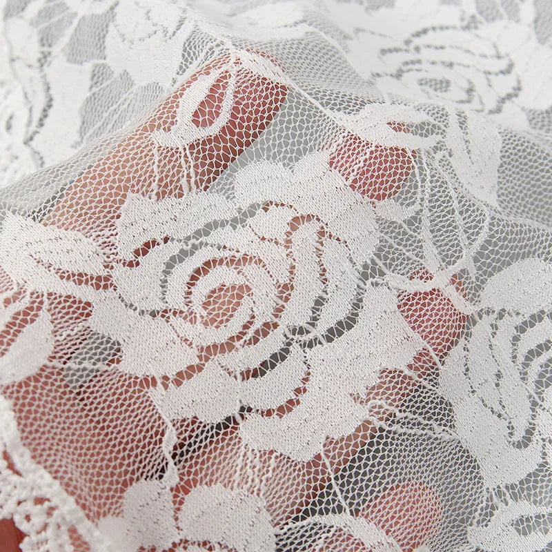 Round white bridal head cover with floral decoration measuring 30cm.