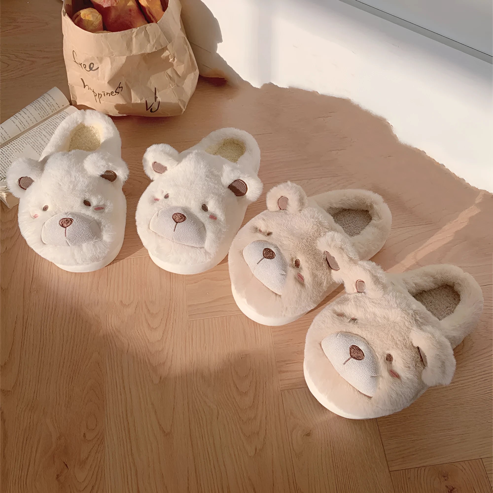 A pair of milky white baotou slippers with suede uppers and a cartoon pattern, showing the round toe shape.