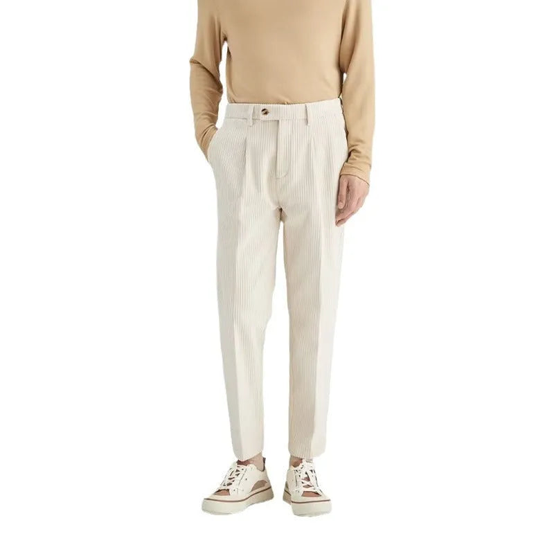 Men's straight-leg corduroy trousers in beige, shown laid flat to display the mid-waist and textured fabric.