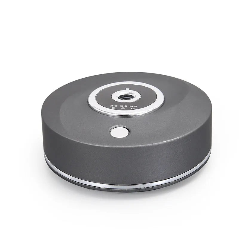 White plastic USB-powered car fragrance spray holder attached to a vehicle air vent.