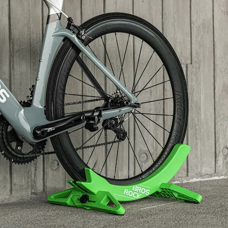 Black ABS plastic wall-mounted bicycle parking rack holder holding a mountain bike.