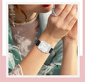 Women's smart bracelet with black gold genuine leather strap and 1.65-inch high-definition screen displaying health metrics.