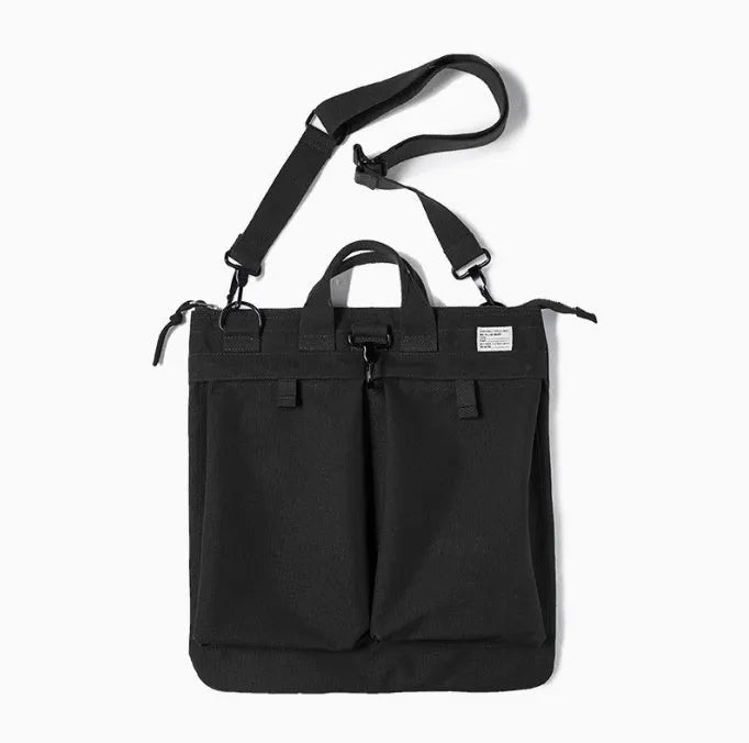 Canvas messenger bag in charcoal black with shoulder strap showing laptop compartment