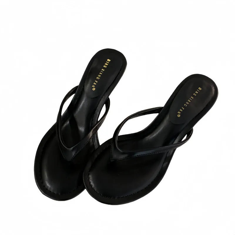 Women's black rubber flip-flop sandals with stiletto heel and round toe on a white background