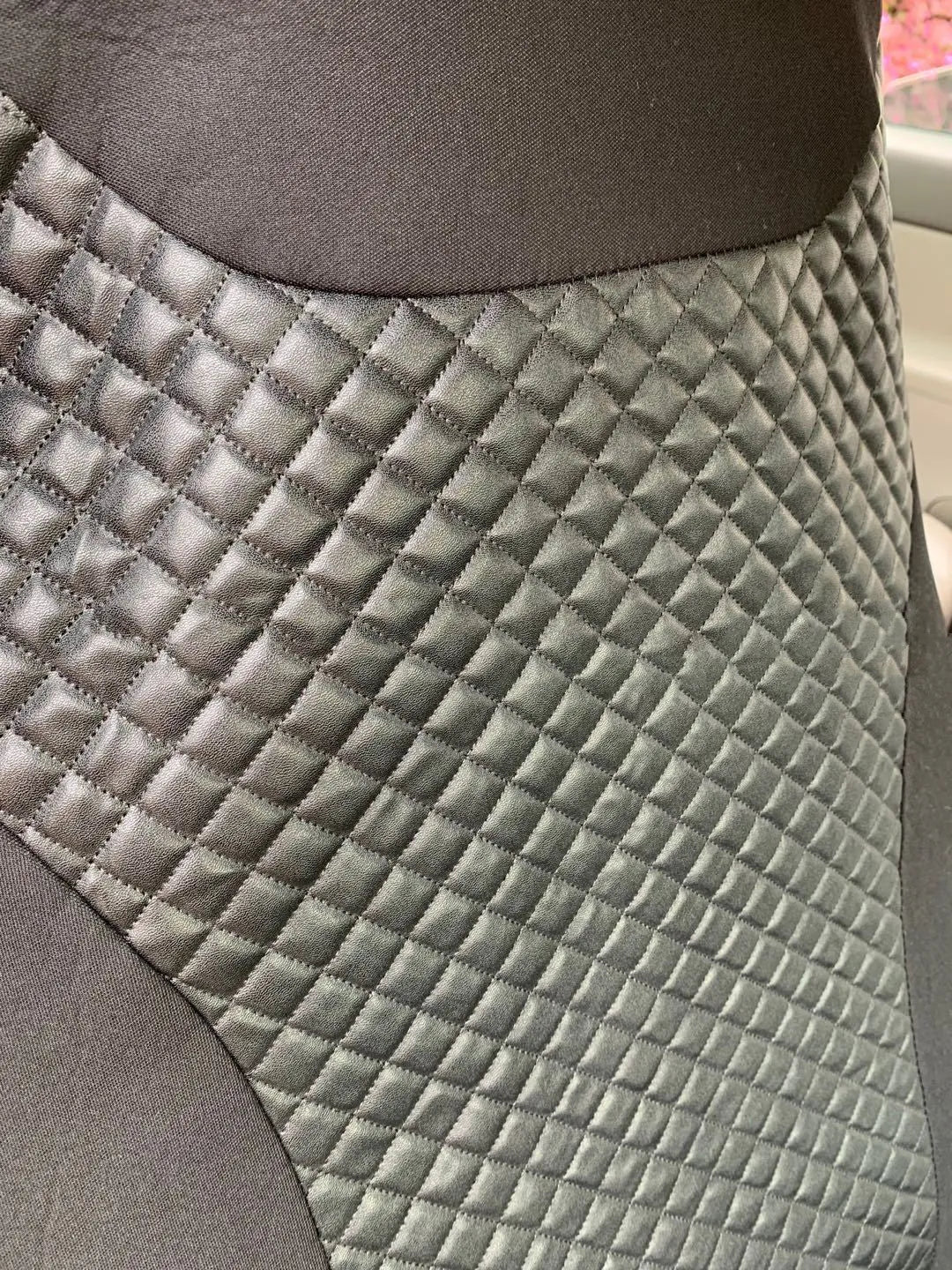 Black quilted automotive seat cover with PU and polyester construction
