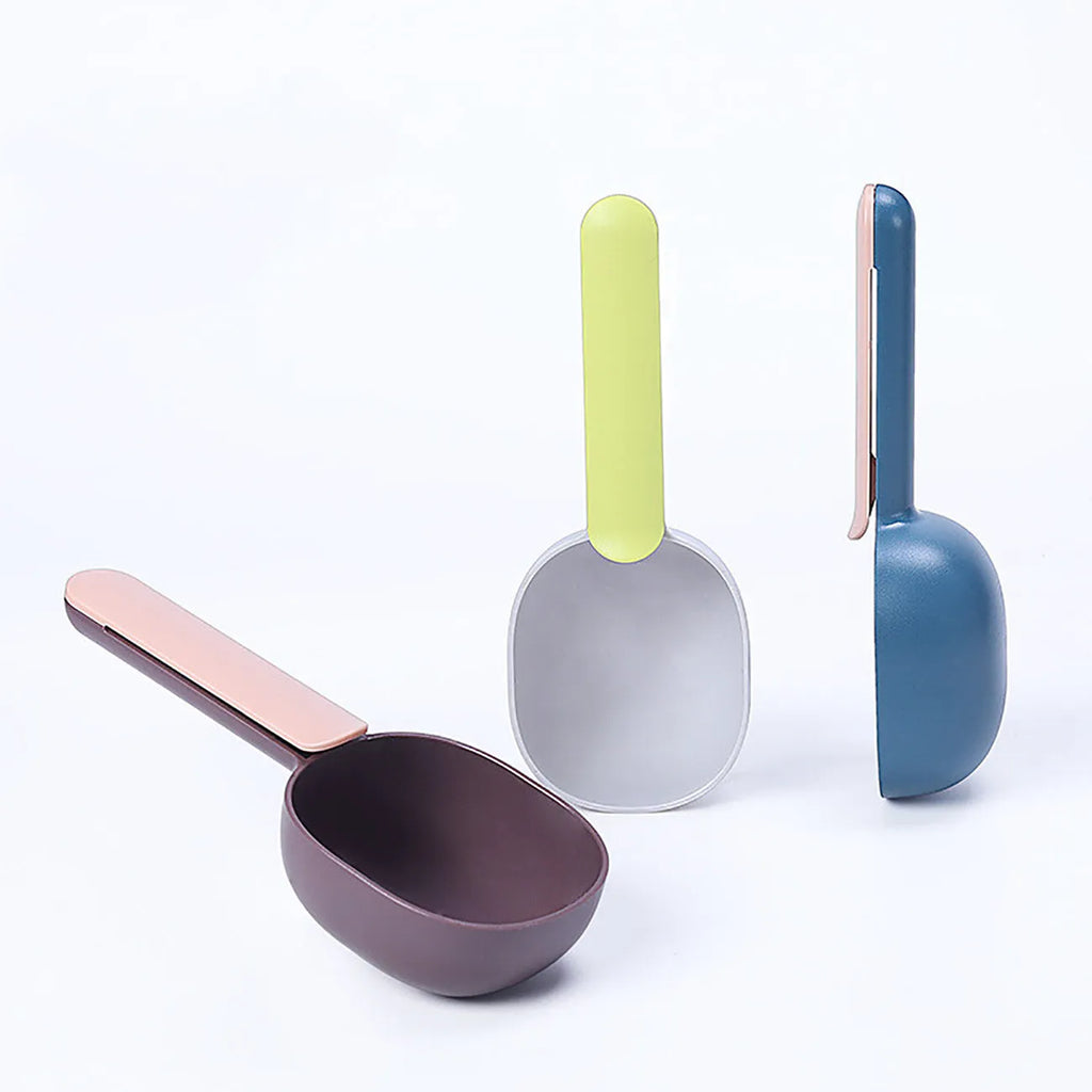 Blue plastic pet food scoop with 1 cup measure and bag clip handle on white background