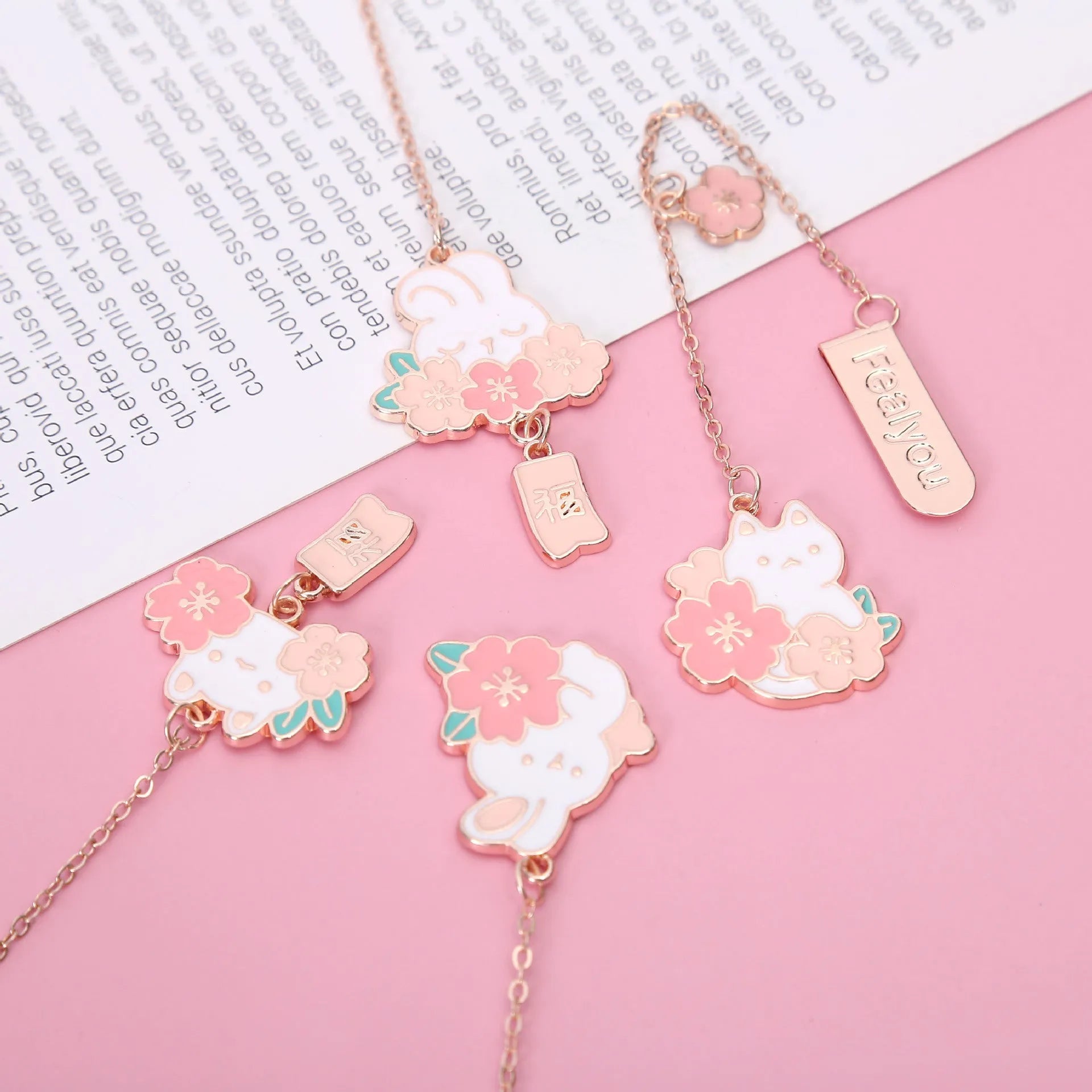 Metal book holder with pendant featuring cute cartoon cherry cat or rabbit sakura design