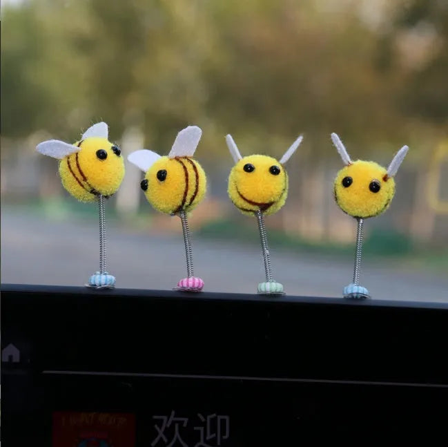 Small yellow and black fur ball bee car decoration ornament measuring 3cm.