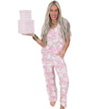 Women's pink Christmas print top and trousers set, short sleeve top, full length trousers, polyester, sizes S-XL.
