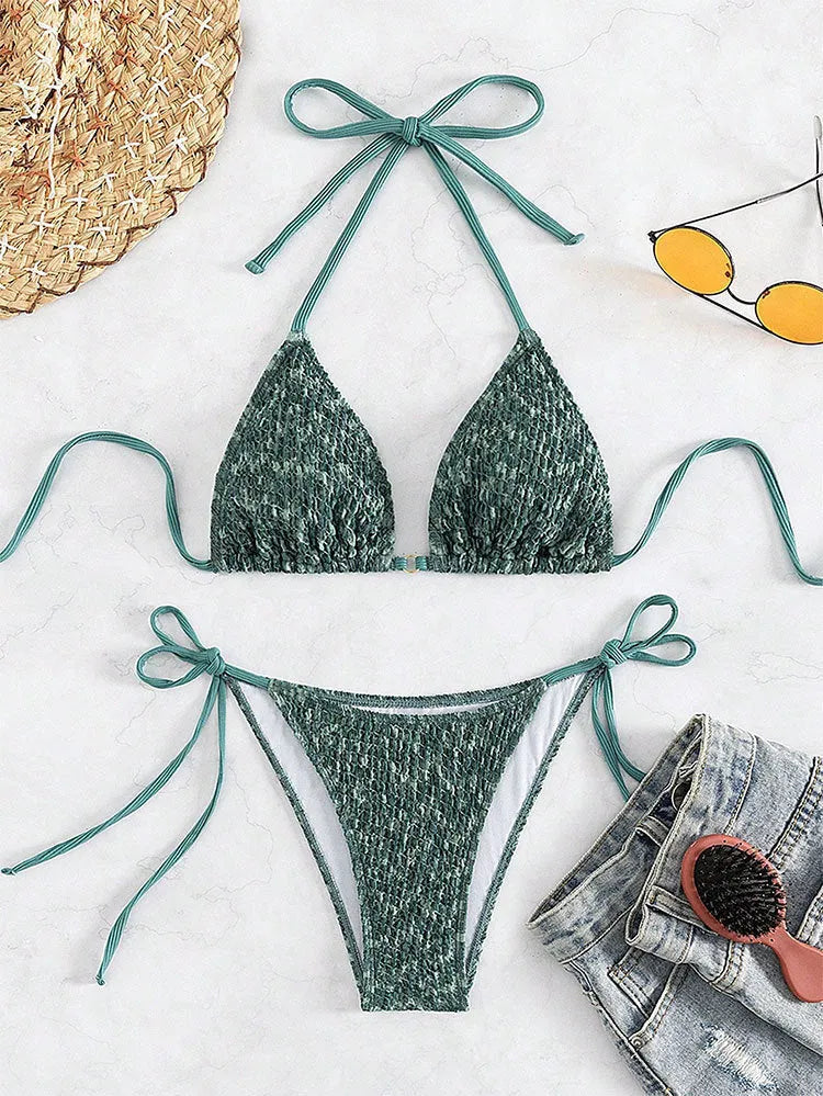 Women's green halter backless swimsuit with three-point design showing front and back styling