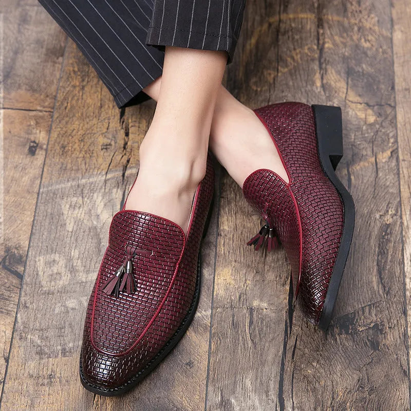 Men's black pointed toe slip-on shoes with a tassel detail on the low-top PU leather upper.