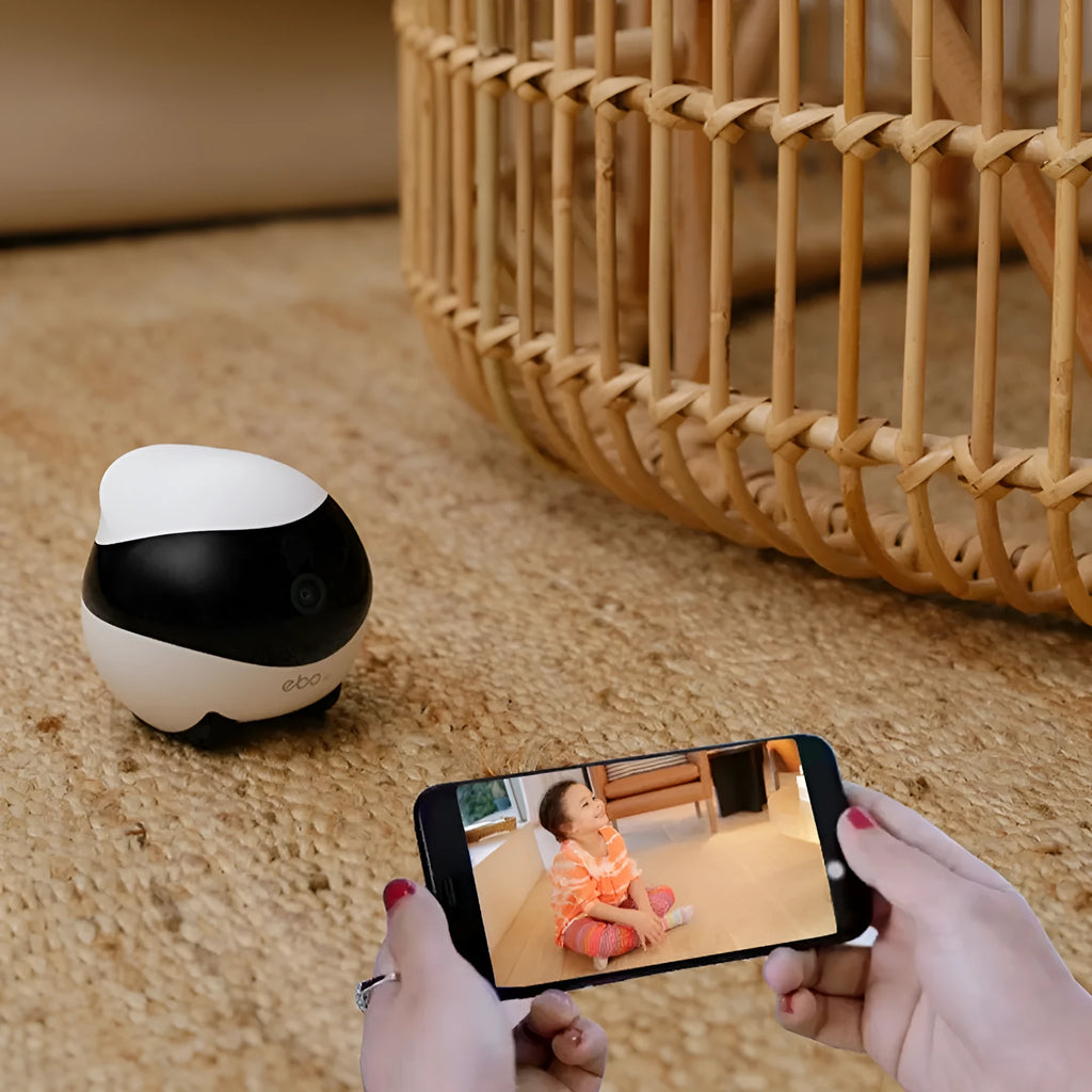 White smart mobile surveillance robot camera with automatic docking station on a floor.