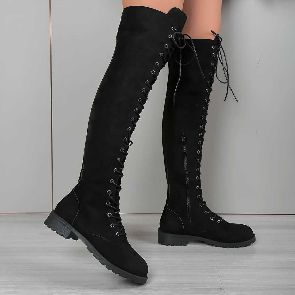 Black lace-up over-the-knee boots with flat heel and round toe on a white background