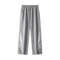 Man wearing grey straight-leg casual trousers with a button fly and elasticated waist.