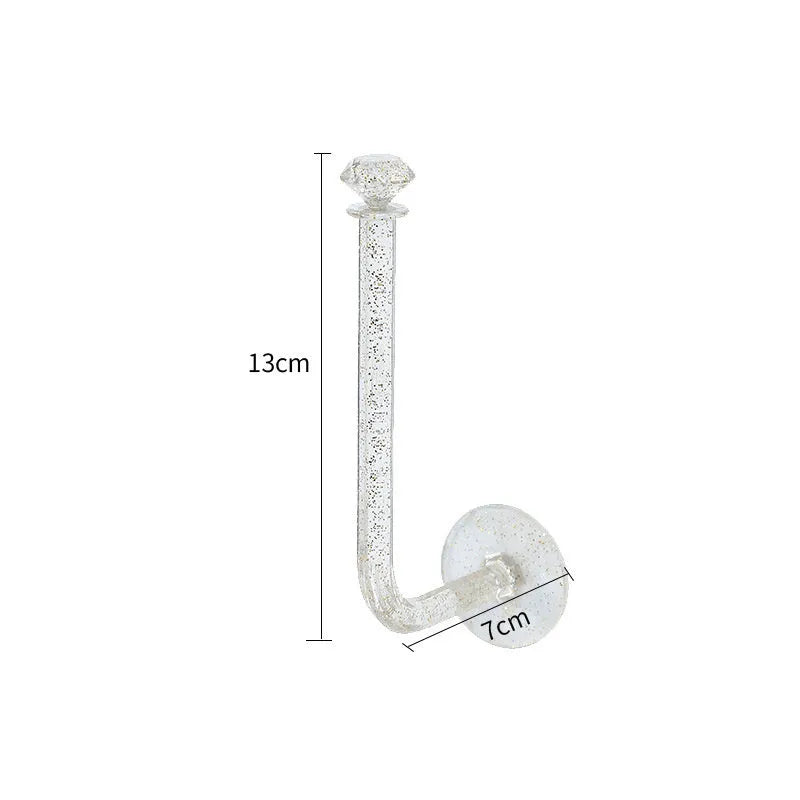 White plastic diamond crystal storage hook mounted on wall holding keys and small accessories
