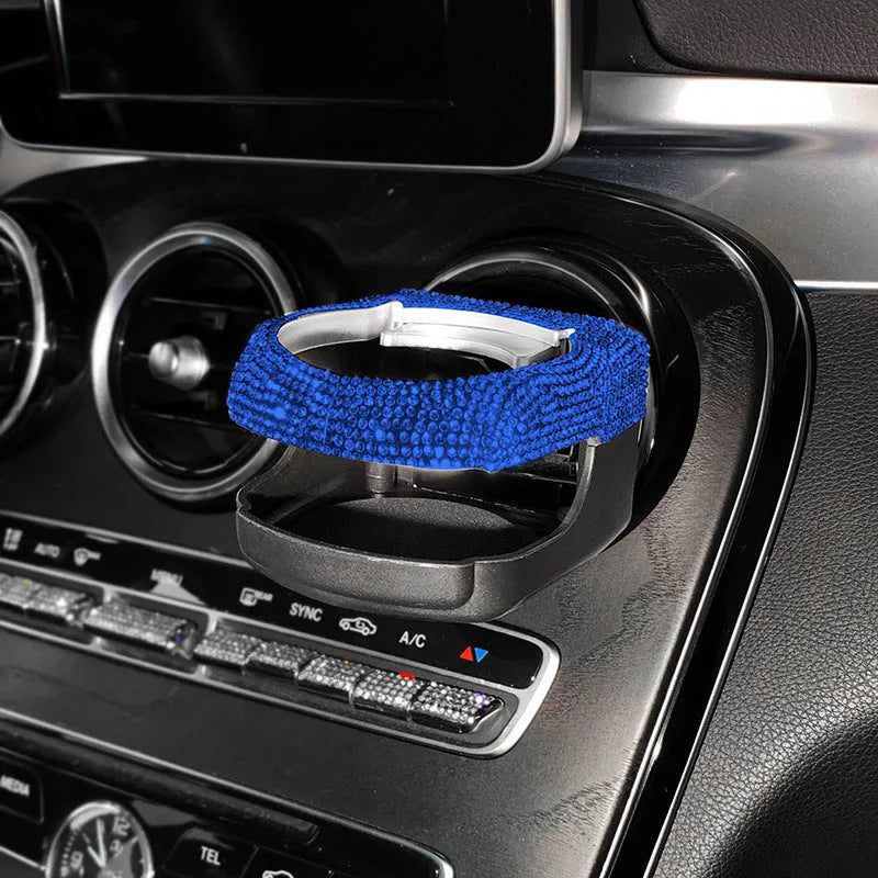Car interior water cup bracket with decorative diamond accents mounted on air vent