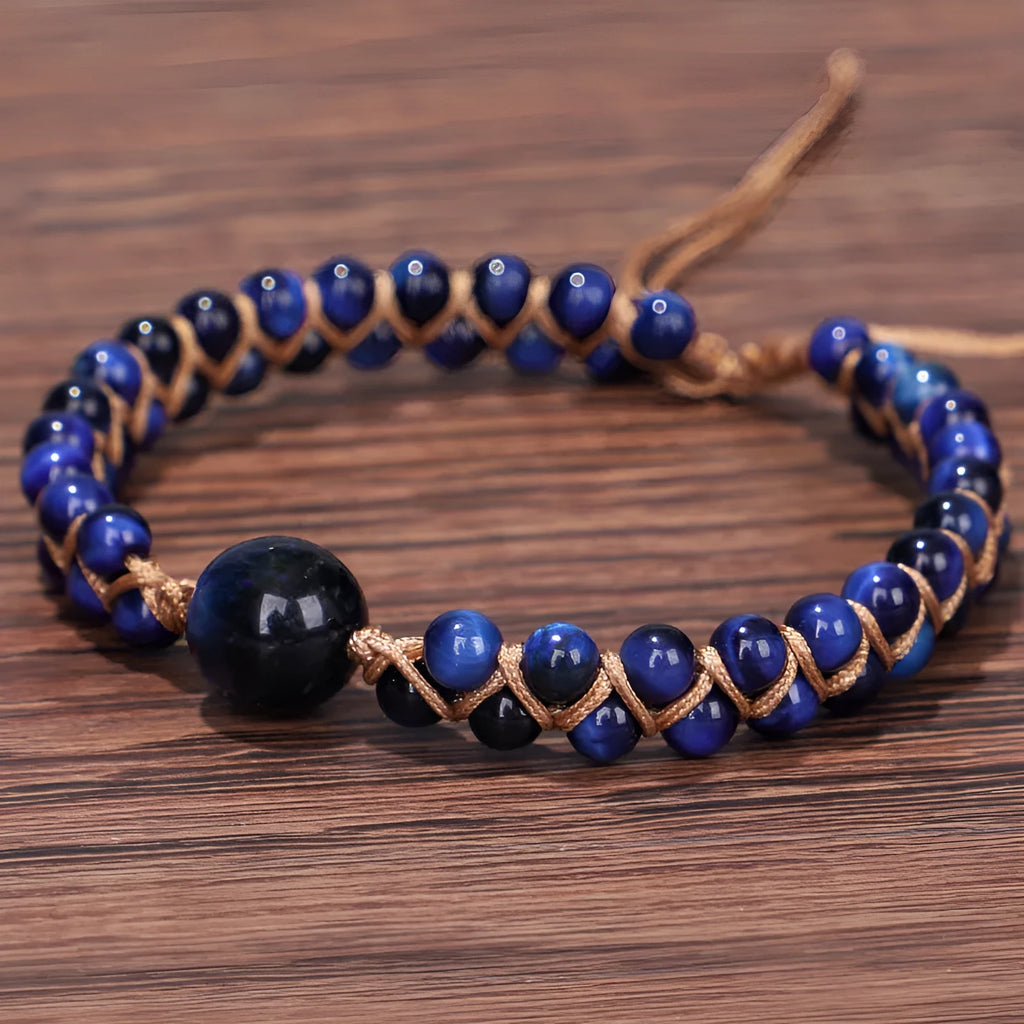 Hand-woven geometric pull bracelet made from blue Tigereye stone beads with an adjustable slip knot.