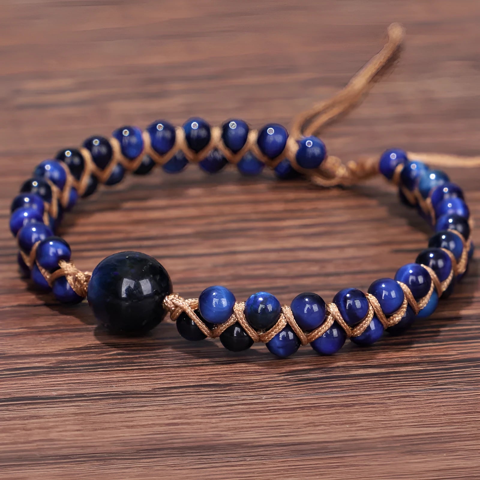 Hand-woven geometric pull bracelet made from blue Tigereye stone beads with an adjustable slip knot.