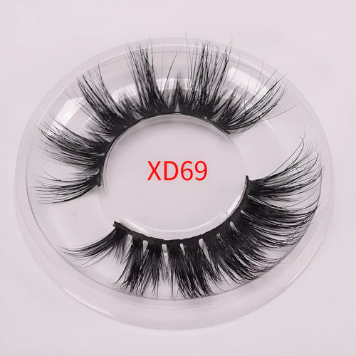 5D mink false eyelashes set with hair storage cap and double-headed brush on a clean surface.