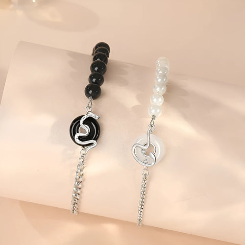 Close-up of a 925 sterling silver bracelet with a safe buckle, featuring obsidian pearls and a detailed snake charm in a new Chinese style.